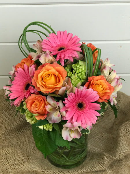 Compact floral arrangement of flowers including lilies, roses, Gerber daisies, and hydrangea from a local flower shop in Belmar, New Jersey Gig Morris Florist
